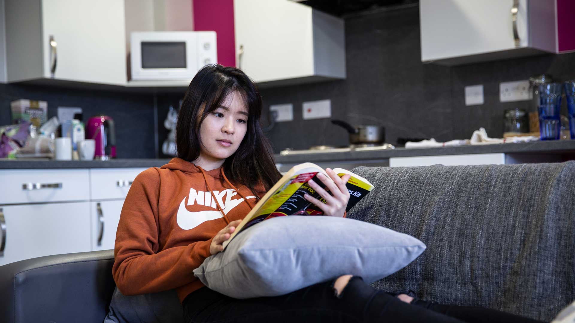 Student at home reading a book