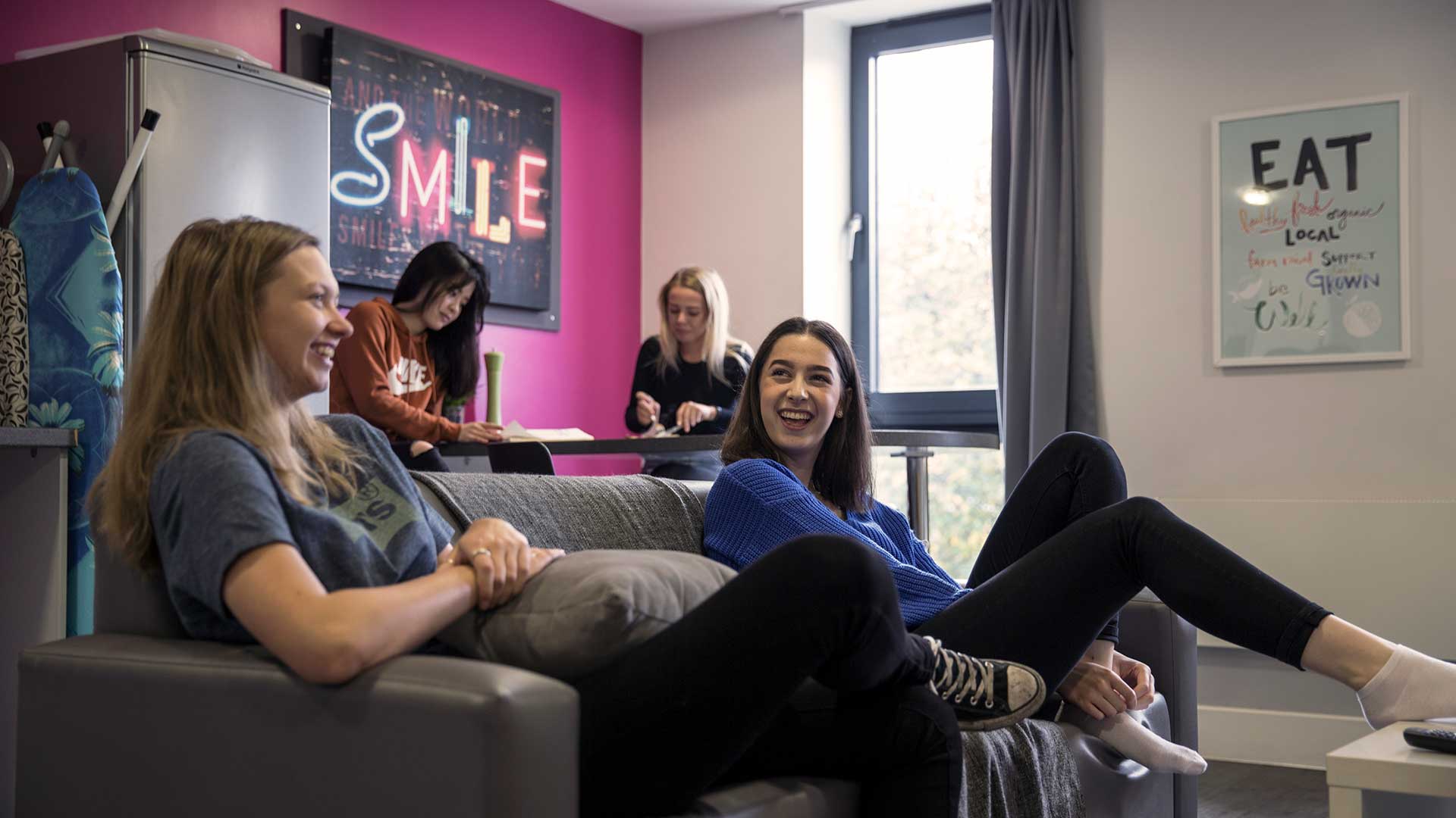 Students laughing in the lounge of their accommodation