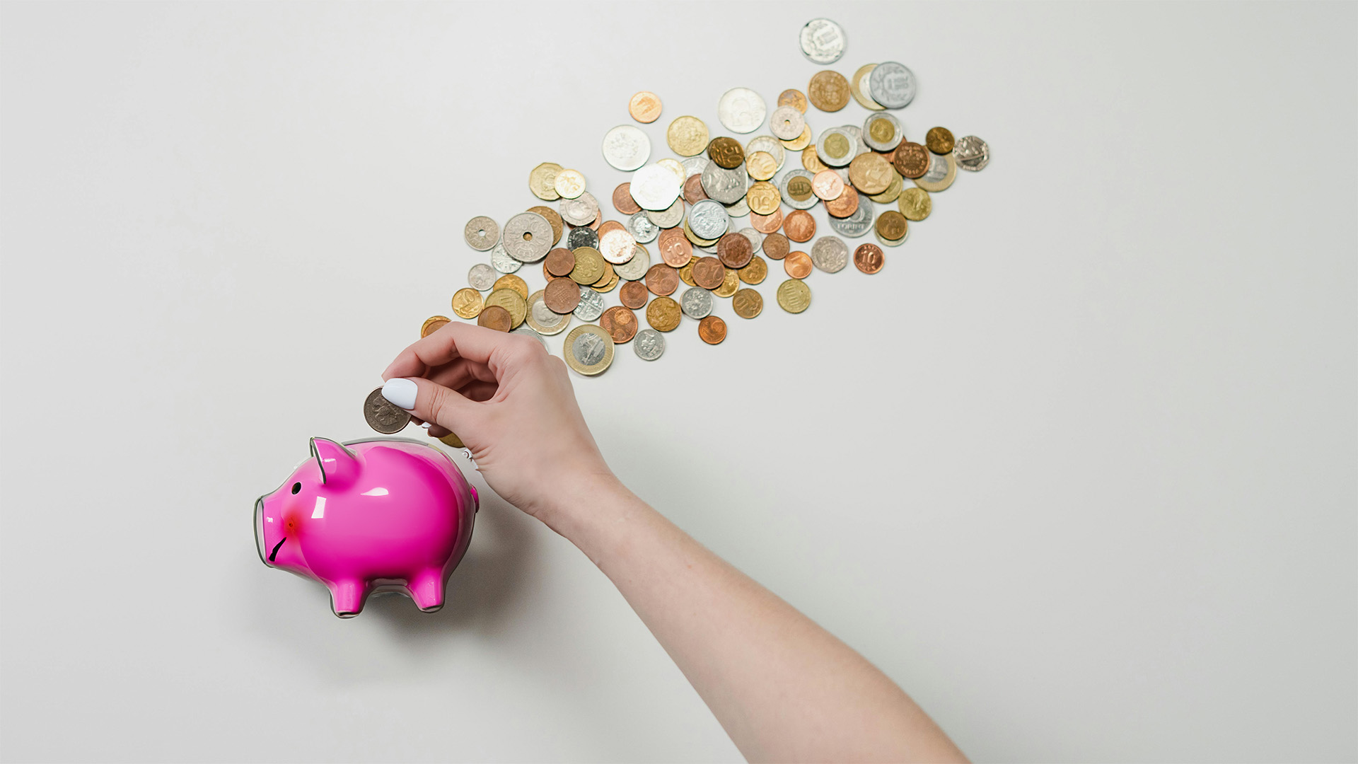 Photo by cottonbro studio, a person putting coins into a piggybank