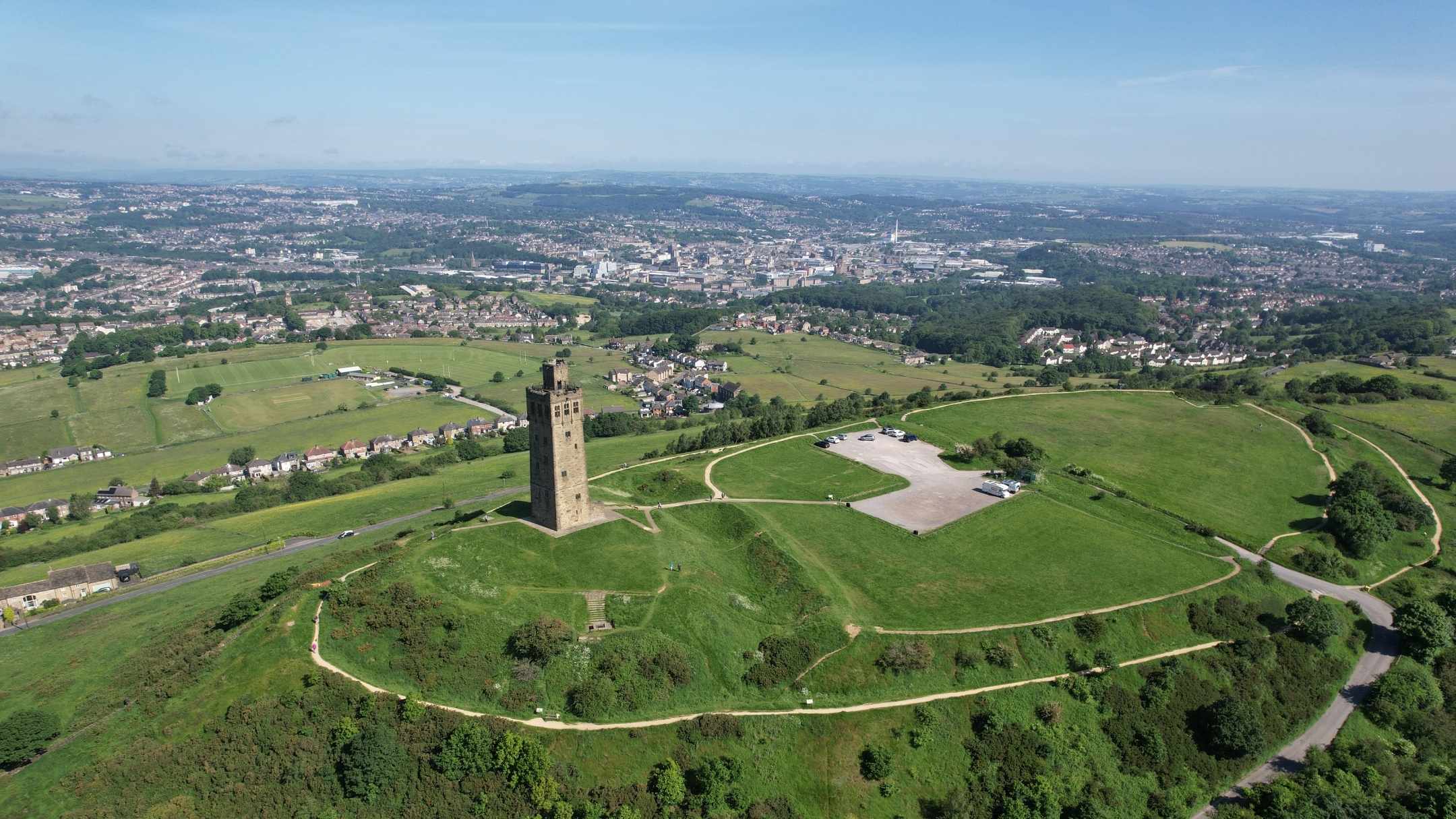 A bird's eye view of Castle Hill with the town of Huddersfield beyond