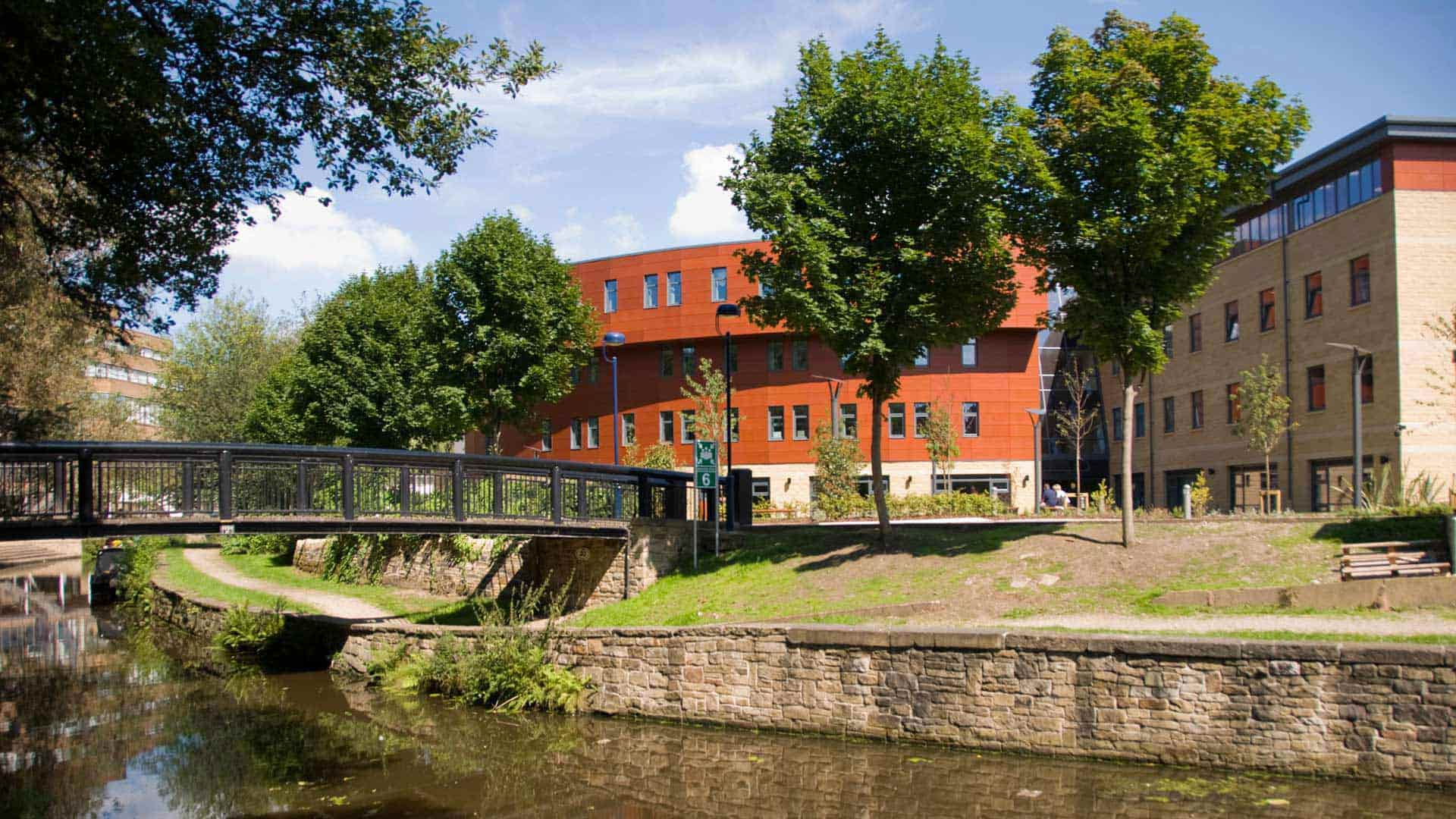 A picture of the Huddersfield Business School from the east overlooking the canal and the bridge which will be used for our websites