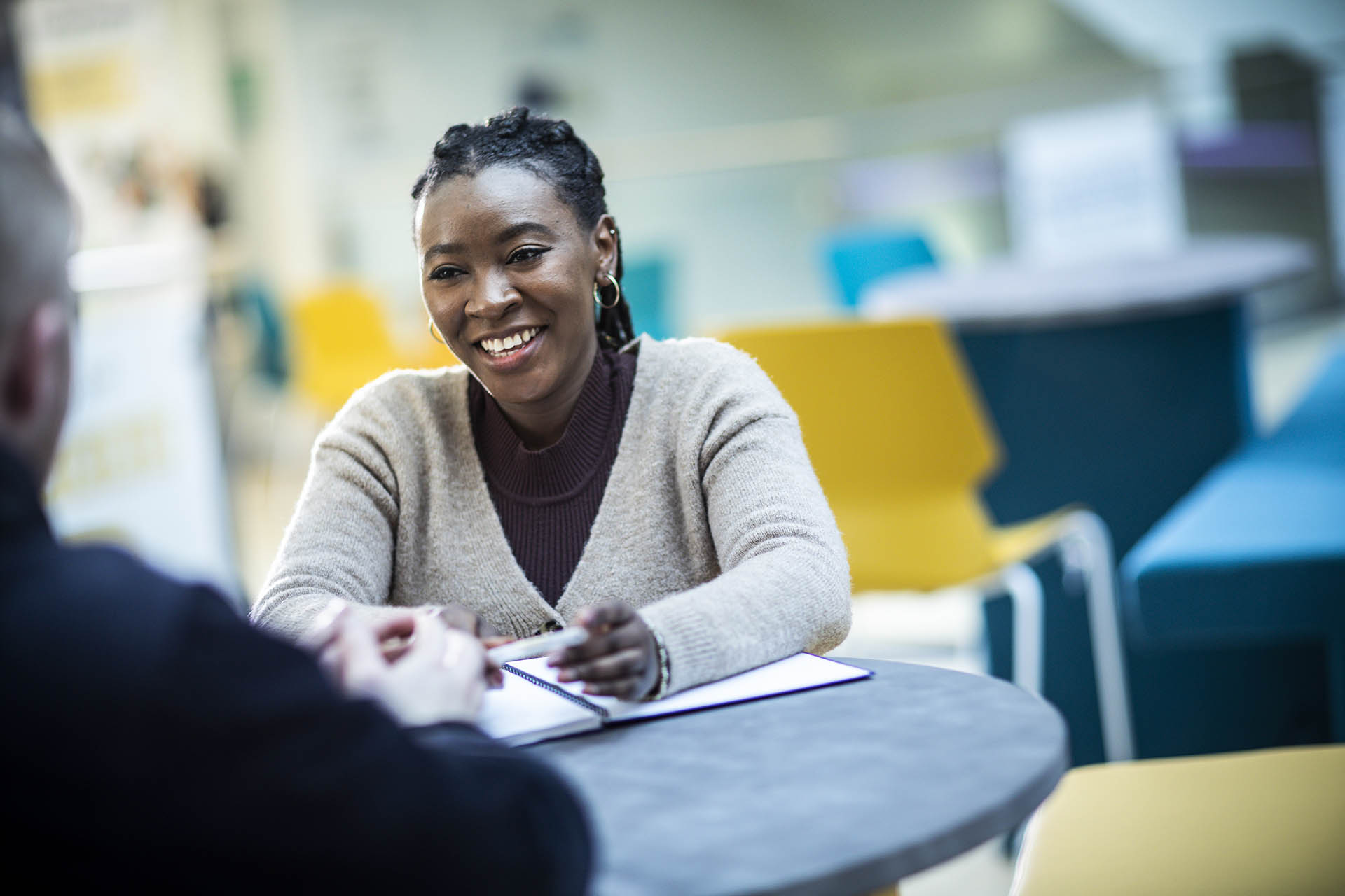 A student in Charles Sikes building sat at a table