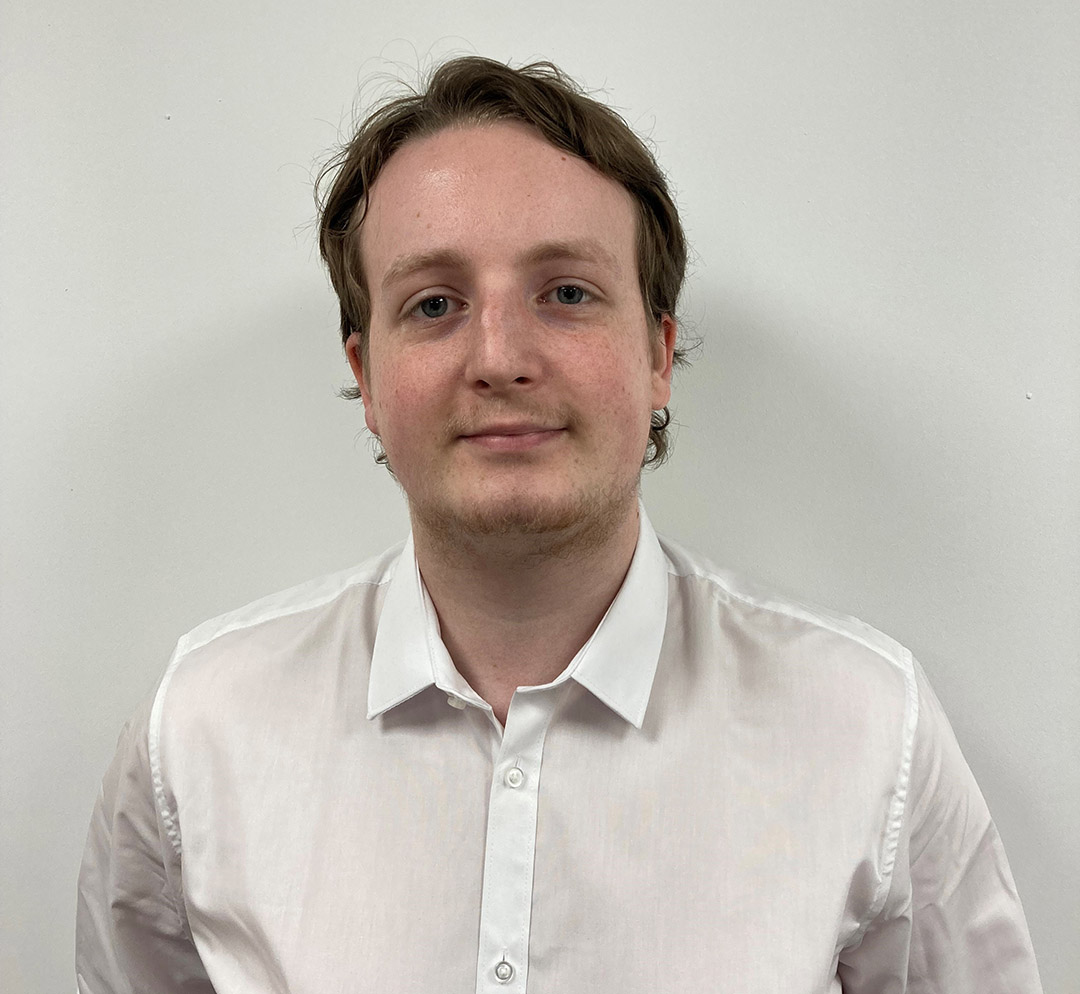 Aidan Froggatt smiling while wearing a white shirt