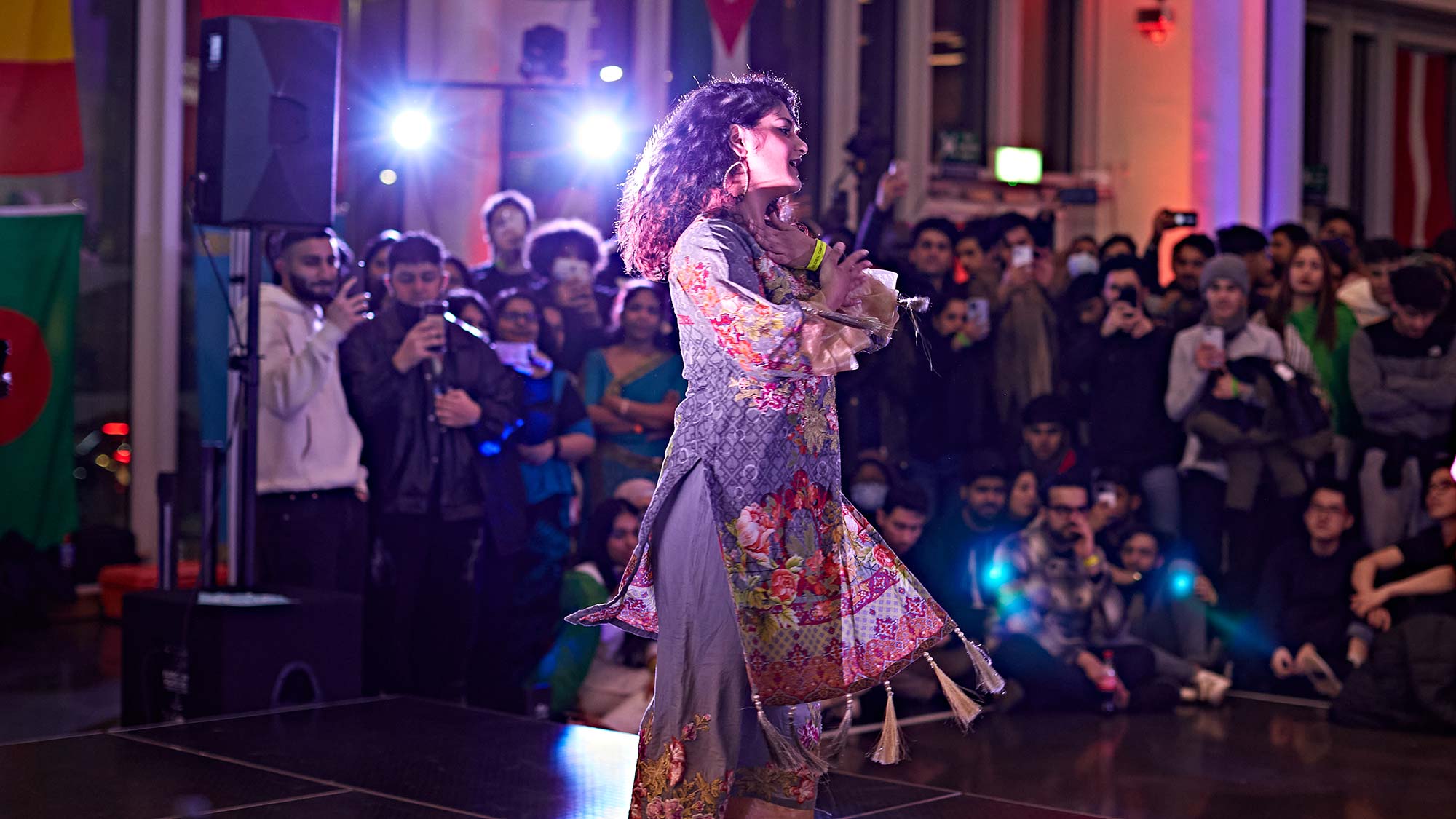 A student performs on stage at the Global food and culture festival. . 