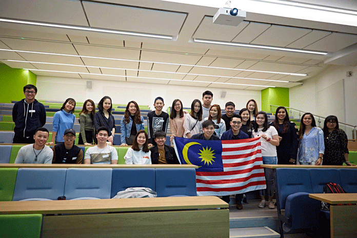 Group photo of Malaysian Student Society with flag