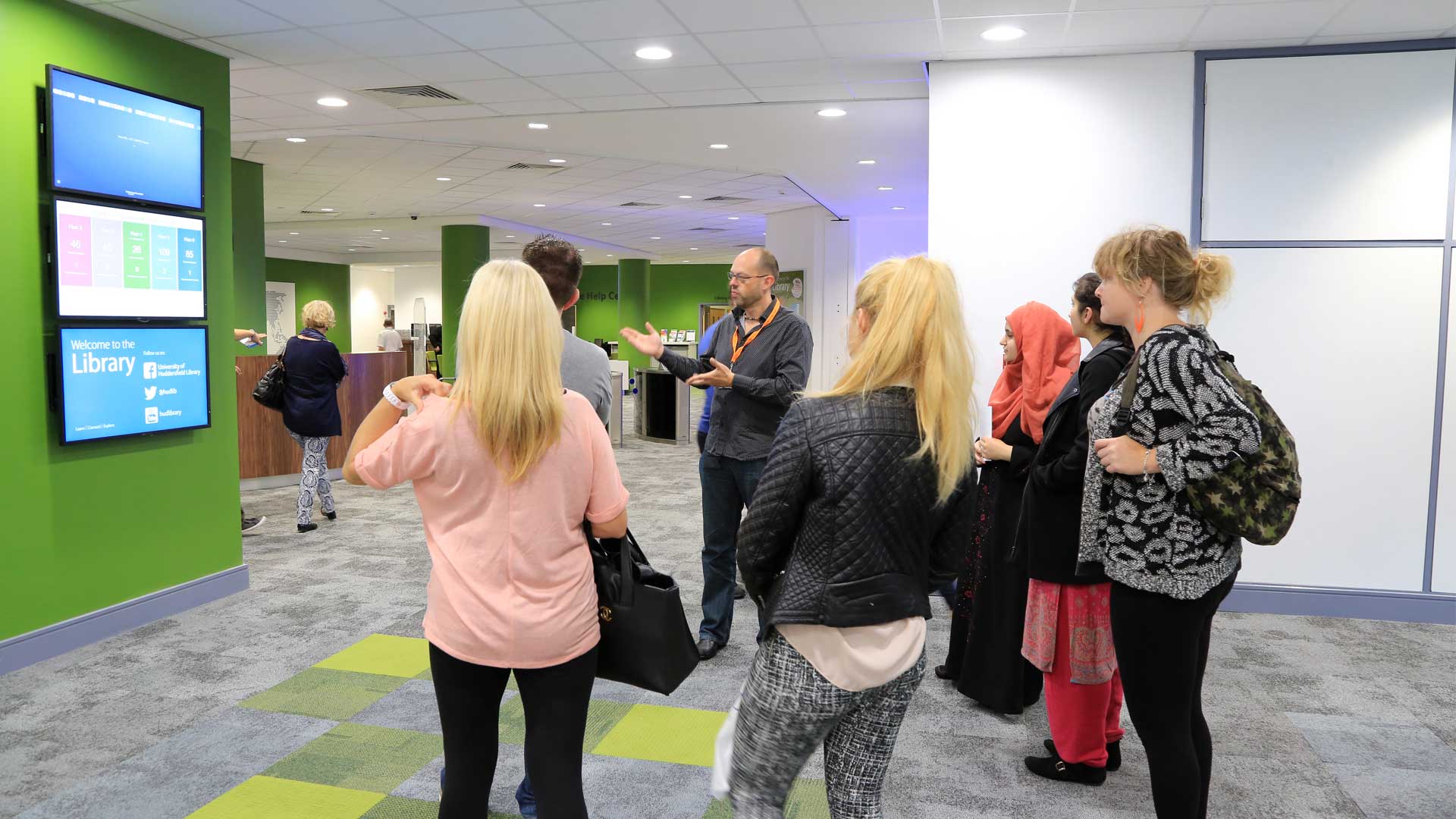 Picture of students being shown the entrance of the Library. 