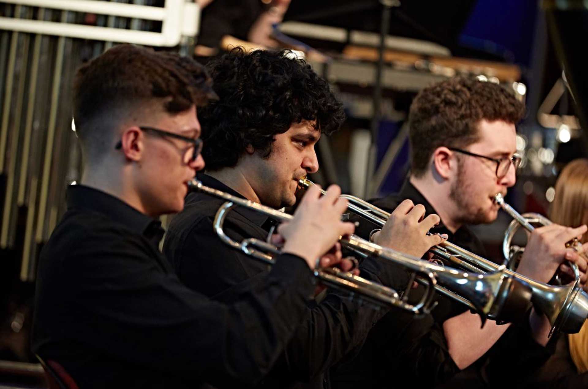 Music students playing brass instruments in St Paul's Hall