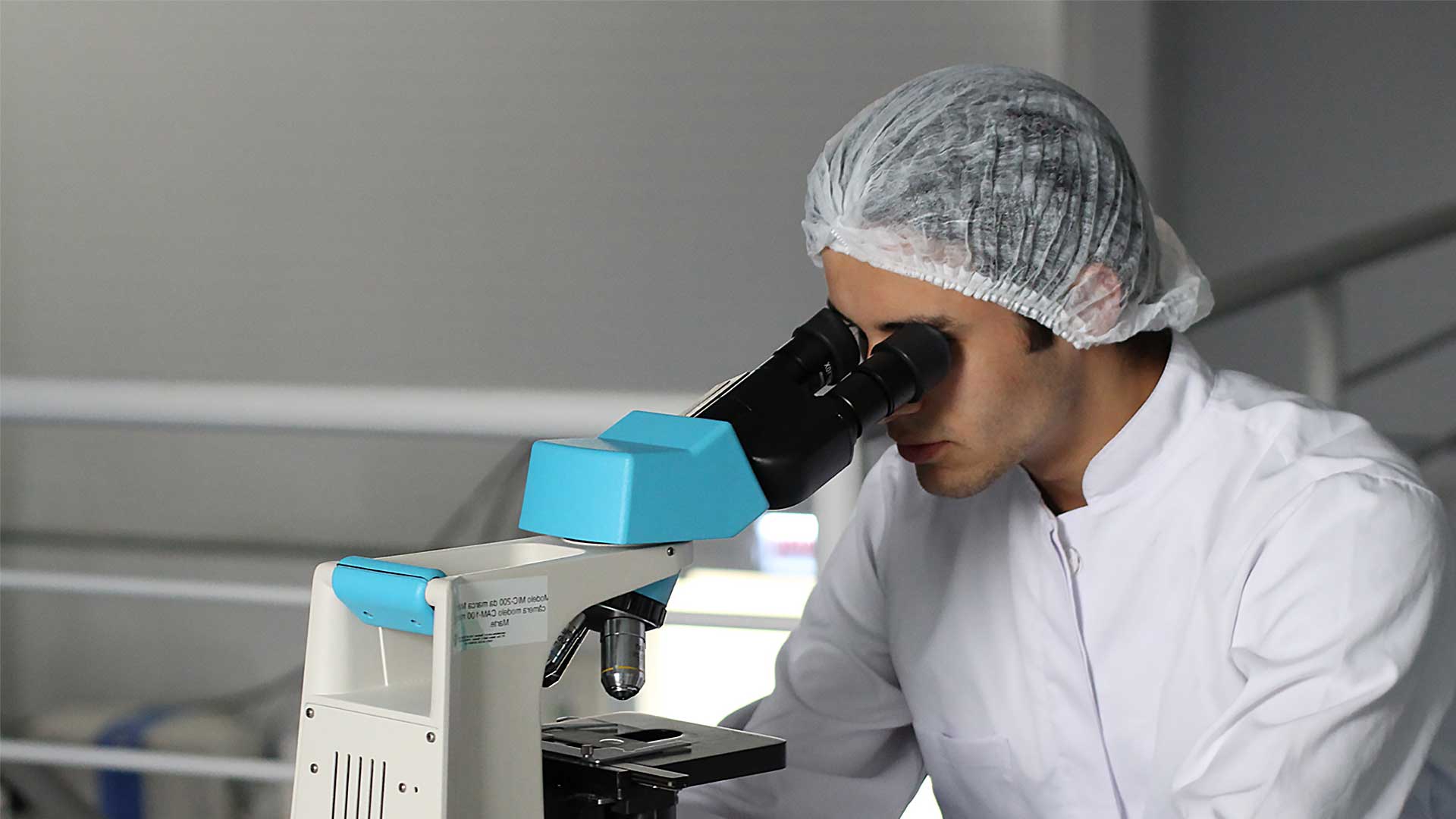 Scientist looking through a microscope