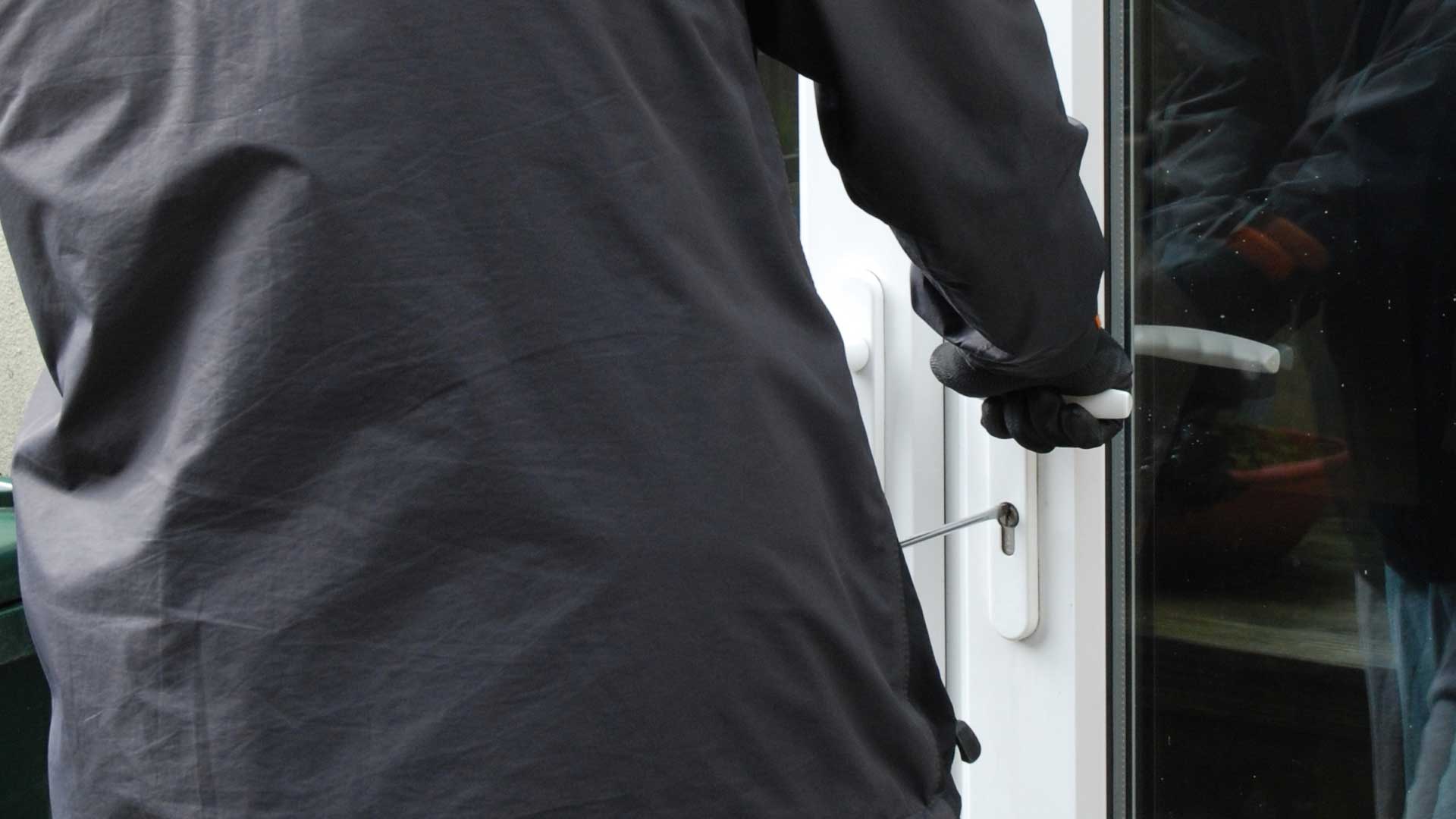 man breaking into a house