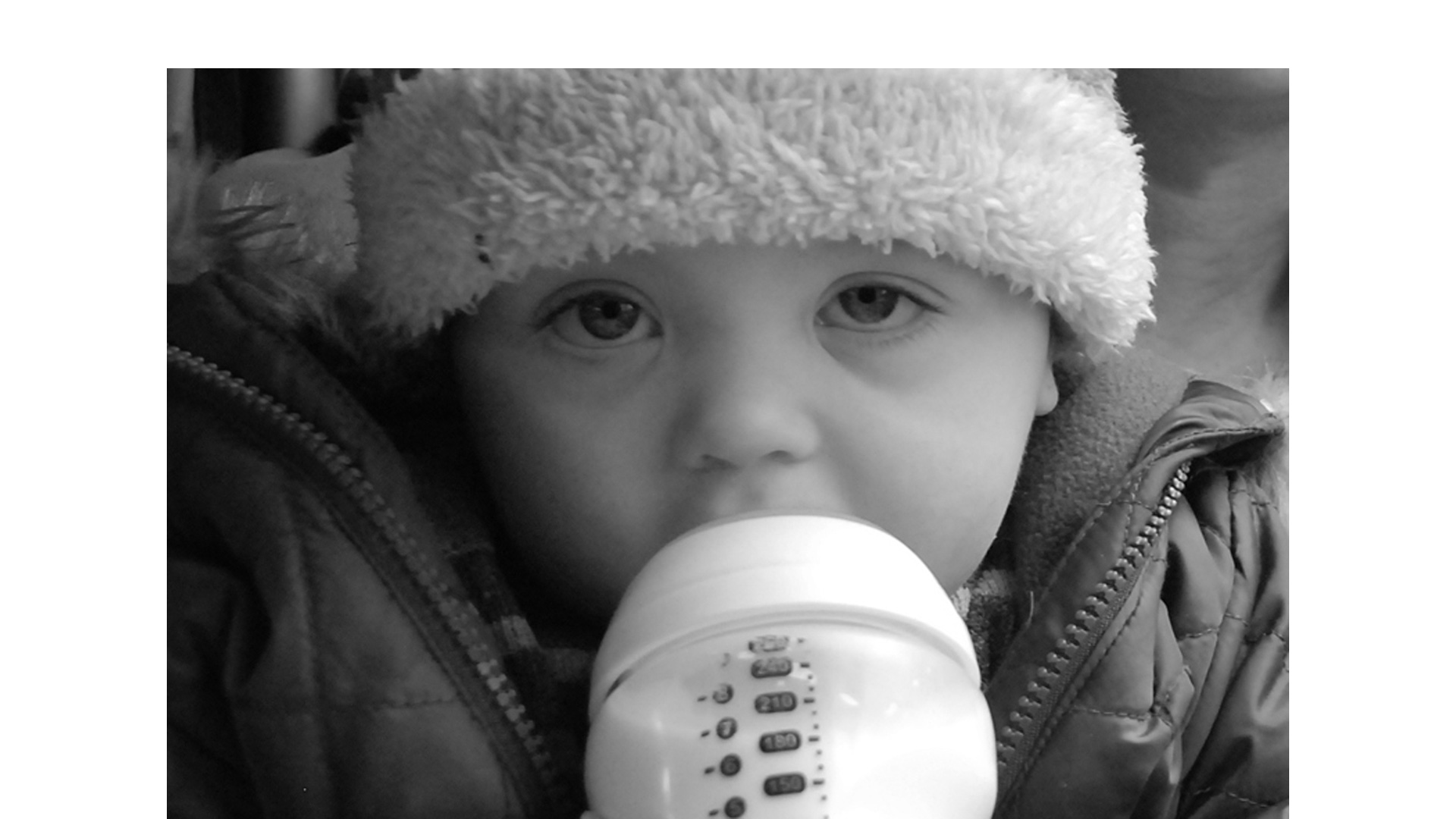 Young child drinking milk from a bottle