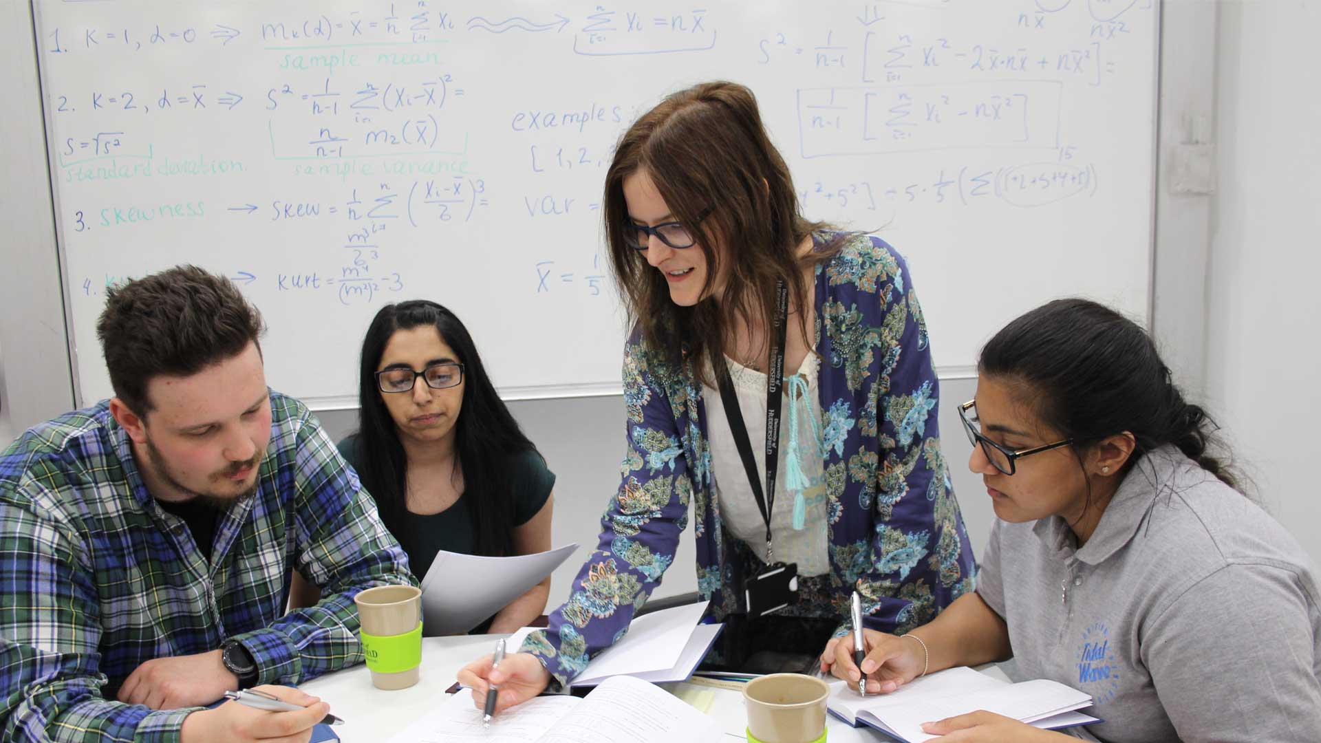 A group of maths students sit around a table studying