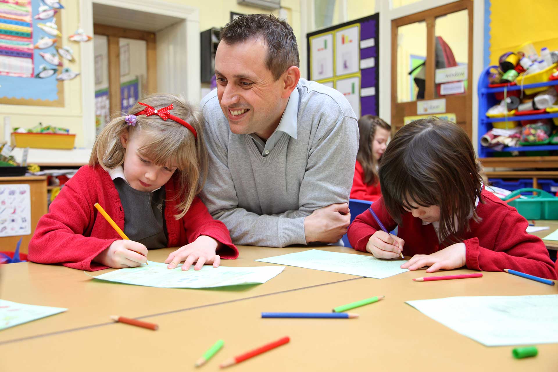 trainee-teacher-with-two-children-at-table